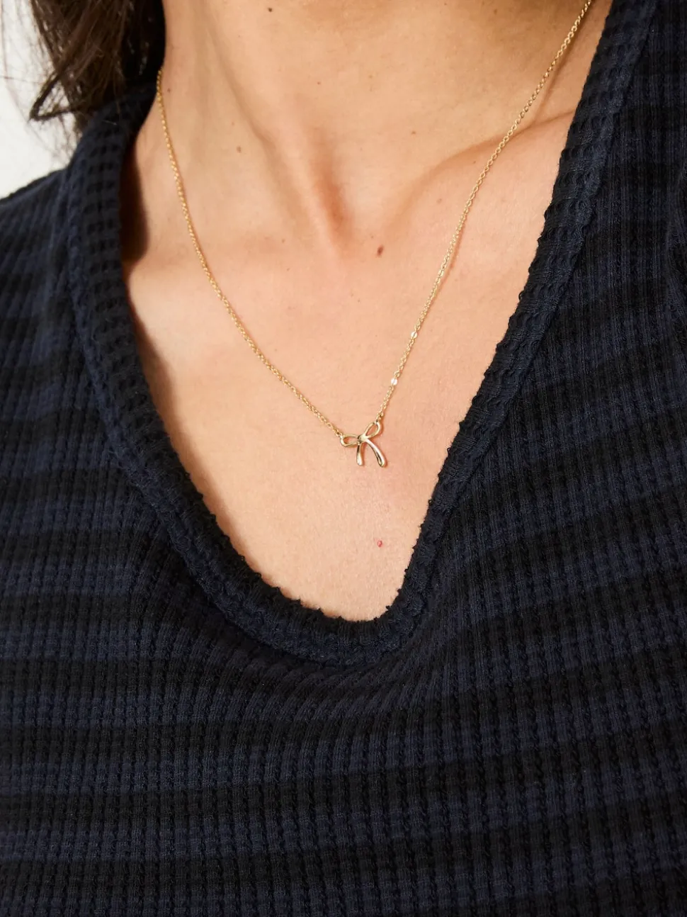 FatFace Gold Tone Bow Pendant Necklace