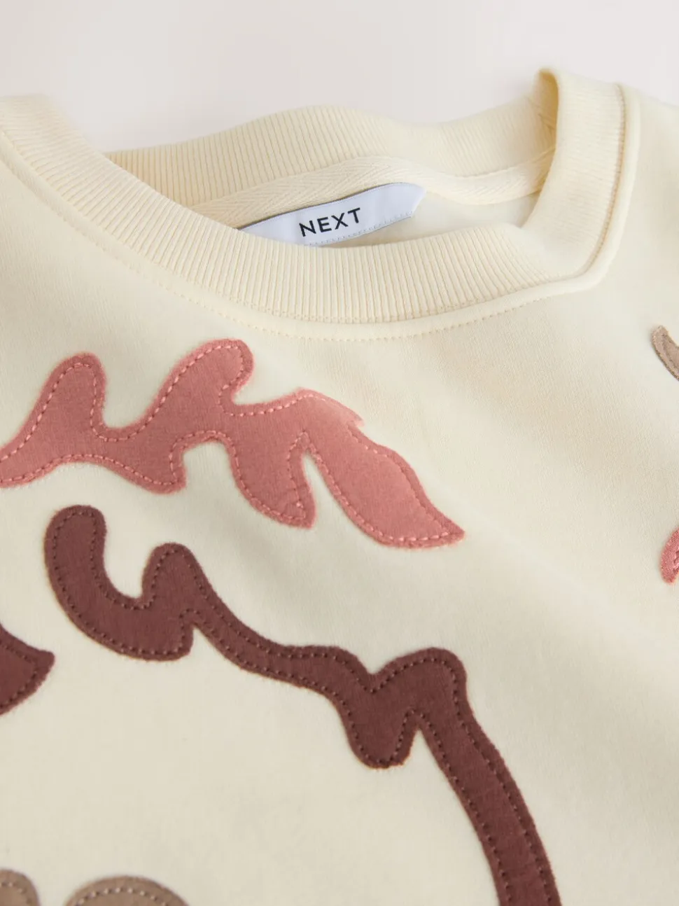 White Sweatshirt with Appliqué Details